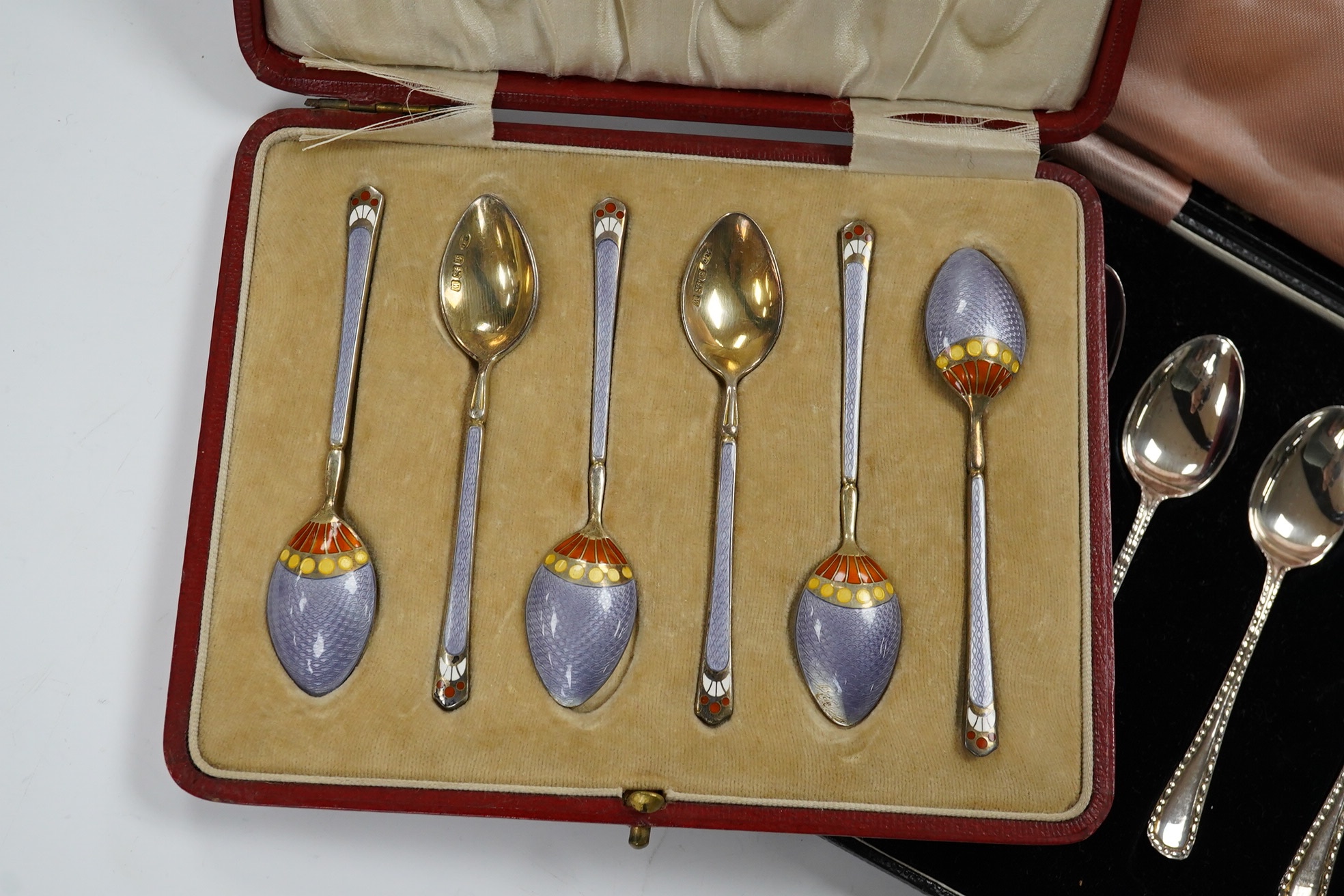 Two cased sets of six silver teaspoons, including enamelled. Condition - poor and good